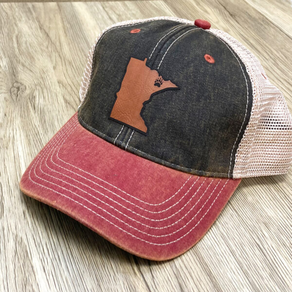 Cream mesh with front denim and red brimmed adjustable hat. Brown leather Minnesota patch on front.