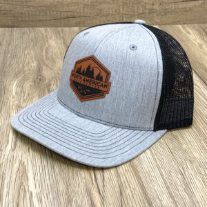 Black mesh with ash gray front hat. Brown leather label with North American Bear Center namedropped.
